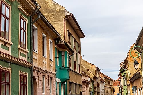 Romania Brasov. 16th century arcaded, and terra cotta roofed houses and narrow streets. Art Print